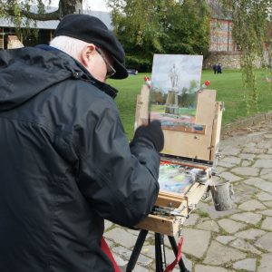 Artist Jerome Hunt painting in Norwich Cathedral Close