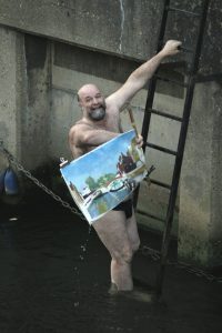Artist John Behm dives in River Wensum from Fye Bridge to save another artist's painting. Photo © Katy Jon Went