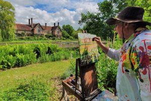 Artist Stephen Johnston painting plein air at Paint Out Elsing Hall Gardens, Norfolk