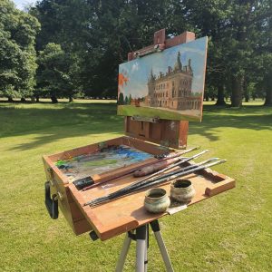 The easel of artist Robert Nelmes painting Houghton Hall at Paint Out Norfolk 2019