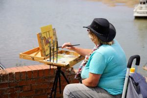 Artist Amanda Barrett painting on Wells-next-the-Sea quayside at Paint Out Norfolk 2020