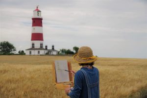 Naomi Clements-Wright painting Happisburgh Lighthouse during Paint Out Norfolk 2020