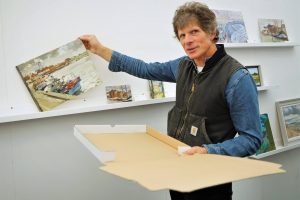 James Colman packages a sold artwork in the posh paintout takeaway pizza box. Photo by Katy Jon Went